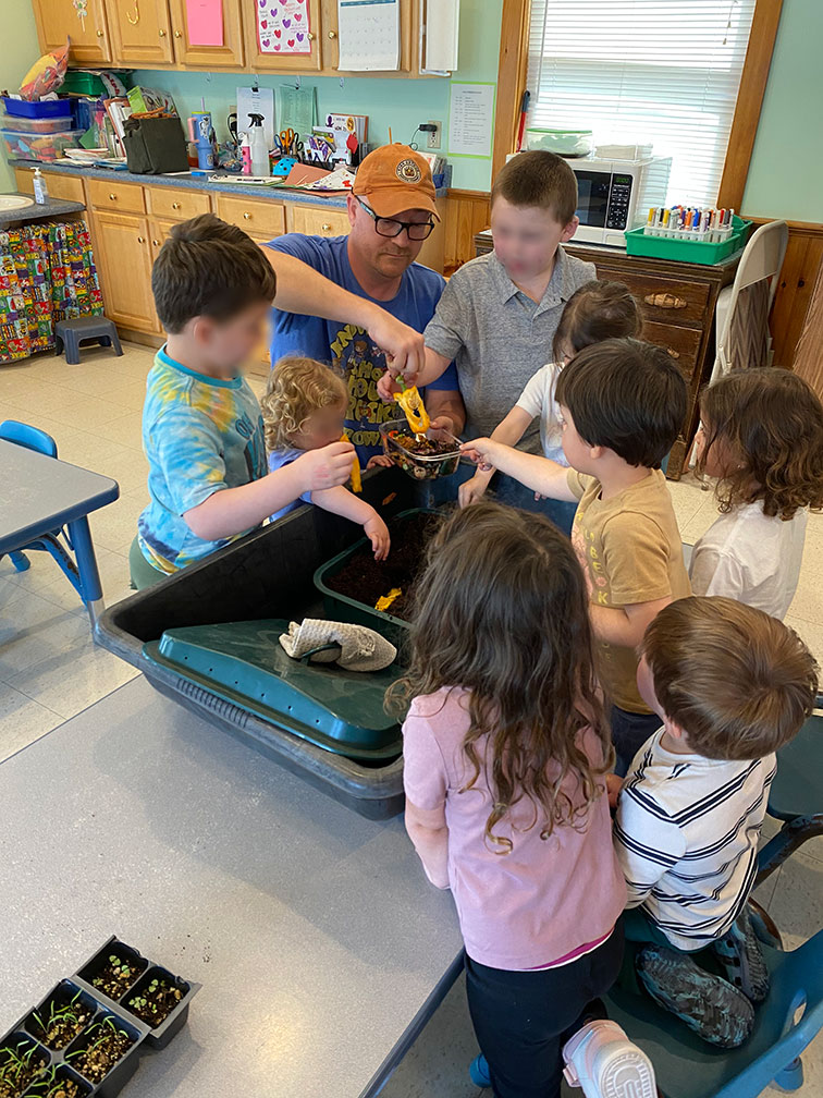 "Pre-schoolers helping to replentish a vermicomposting bin"